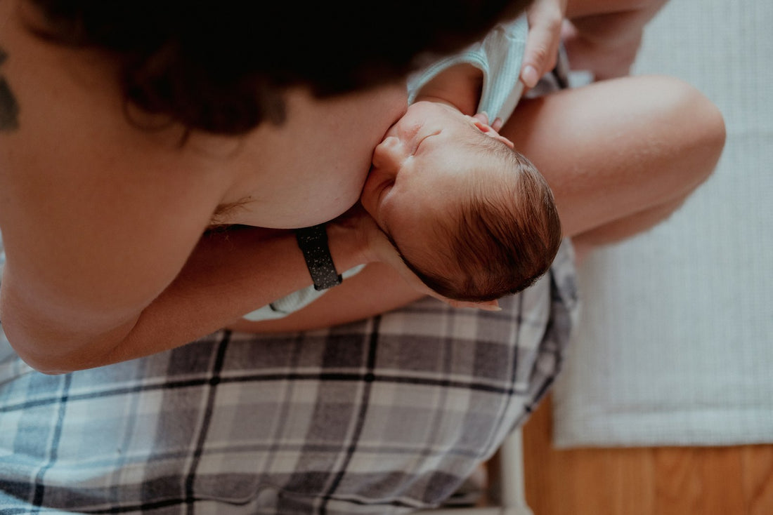 Mom holding her baby in her lap during a quiet moment at home